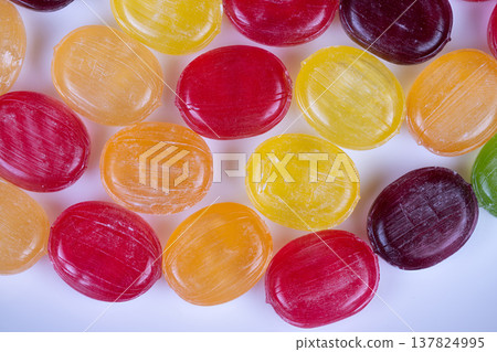 Bright candy photograph for display. Vivid multicolored confection product photo showcase. Cleanly styled candy image highlighting various vibrant pieces prominently 137824995