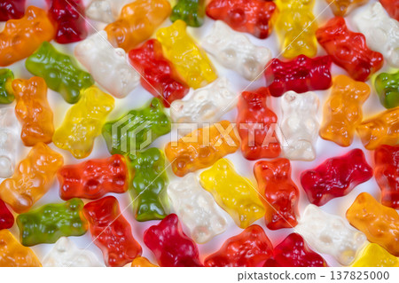 Colorful gummy bears. Bright gummy bears pattern design. Multicolored gummy bears with vivid translucent colors. Highangle view of vibrant gummy bears with light and shallow focus Colorful gummy bears. Bright gummy bears pattern design. Multicolored gummy bears with vivid translucent colors. Highangle view of vibrant gummy bears with light and shallow focus 137825000