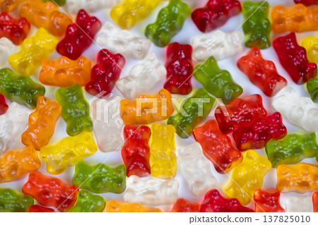 Tight abstract mosaic of multicolored gummy bears, overlapping silhouettes and varied hues create visual rhythm and contemporary art feel suitable for creative campaigns Tight abstract mosaic of multicolored gummy bears, overlapping silhouettes and varied hues create visual rhythm and contemporary art feel suitable for creative campaigns 137825010
