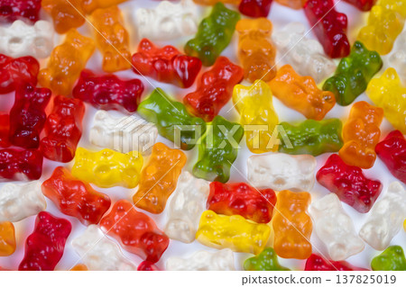 Colorful gummy backdrop. Vibrant gummy bear pattern ready. Bright multicolored gummy bears for designs. Repeatable and vivid gummy bears for creative branding templates 137825019