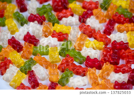 Playful gummy bear artistry. Vibrant gummy bears create miniature artistic display. Brightly colored gummy candies arranged into small artistic sculpture for visual appeal Playful gummy bear artistry. Vibrant gummy bears create miniature artistic display. Brightly colored gummy candies arranged into small artistic sculpture for visual appeal 137825033