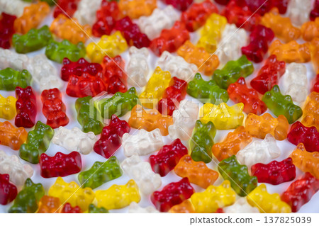 Eyecatching gummy bear arrangement suitable for promotional purposes. Dynamic and colorful gummy bear texture designed for packaging and advertising applications Eyecatching gummy bear arrangement suitable for promotional purposes. Dynamic and colorful gummy bear texture designed for packaging and advertising applications 137825039