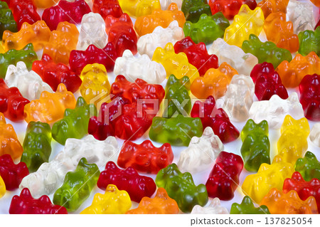 Patterned rows of multicolored gummy bears captured in crisp light, productstyle composition for packaging mockups and ecommerce hero imagery with polished sugar sheen Patterned rows of multicolored gummy bears captured in crisp light, productstyle composition for packaging mockups and ecommerce hero imagery with polished sugar sheen 137825054