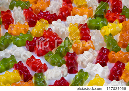 Multicolored gummy bears arranged for party theme, festive color palette with red, yellow and green gummies, lively vibes and celebrationready display with glossy highlights 137825066