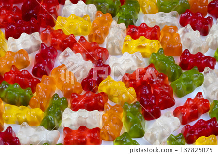 Multiple colored gummy bears with translucent edges and bubbles pattern. Repeating pattern of multicolored gummy bears showcasing transparency and vibrant saturation Multiple colored gummy bears with translucent edges and bubbles pattern. Repeating pattern of multicolored gummy bears showcasing transparency and vibrant saturation 137825075