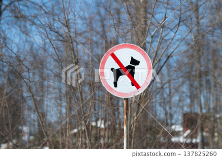 Peaceful snowy suburban landscape. Frozen snow under rusted metal after snowfall. Serene winter scene in suburb showing no dogs sign and icy snow beneath aged metal post Peaceful snowy suburban landscape. Frozen snow under rusted metal after snowfall. Serene winter scene in suburb showing no dogs sign and icy snow beneath aged metal post 137825260