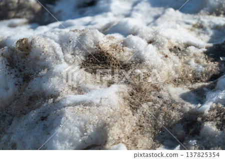 Ground thaws with scattered patches. Frosted ground starts revealing earth beneath. Seasonal thaw reveals patches of exposed soil amid residual ice and patches of greenery Ground thaws with scattered patches. Frosted ground starts revealing earth beneath. Seasonal thaw reveals patches of exposed soil amid residual ice and patches of greenery 137825354