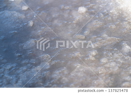 Frozen spring thaw. Bright spring ice with delicate frost. Early spring frost captures melted ice sparkle. Photographer documents melting ice and frost on city spring morning Frozen spring thaw. Bright spring ice with delicate frost. Early spring frost captures melted ice sparkle. Photographer documents melting ice and frost on city spring morning 137825478