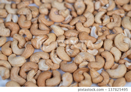 Proteinrich cashews scattered across surface, natural pale and toasted tones emphasize nutrientdense snack option, perfect for fitness, nutrition and healthy lifestyle content Proteinrich cashews scattered across surface, natural pale and toasted tones emphasize nutrientdense snack option, perfect for fitness, nutrition and healthy lifestyle content 137825495