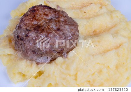 Juicy beef cutlet on mash. Closeup of beef with crispy crust and smooth mash. Studio styled photo capturing juicy beef and velvety mashed potatoes with detailed crust Juicy beef cutlet on mash. Closeup of beef with crispy crust and smooth mash. Studio styled photo capturing juicy beef and velvety mashed potatoes with detailed crust 137825520