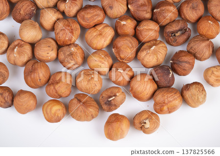 Nut pattern design. Natural hazelnut arrangement creates adaptable background. Repetitive hazelnut shapes produce versatile visual textures suitable for various applications Nut pattern design. Natural hazelnut arrangement creates adaptable background. Repetitive hazelnut shapes produce versatile visual textures suitable for various applications 137825566