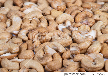 Warm lighting with healthy snack. Invitation to share nutritious cashews casually. Welcoming presentation of roasted cashews in intimate environment encouraging conversation Warm lighting with healthy snack. Invitation to share nutritious cashews casually. Welcoming presentation of roasted cashews in intimate environment encouraging conversation 137825572