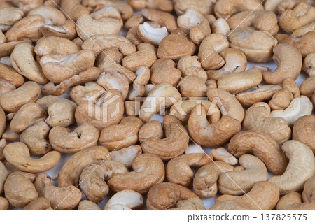 Gourmet seasoned nut snack. Artisan seasoned cashews with aromatic and spicy accents. Premium roasted cashew nuts featuring visible spice flecks and rich aroma details 137825575