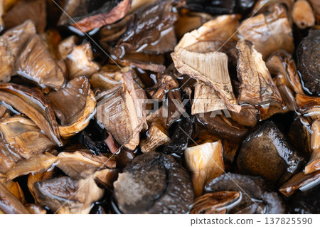 Arrange dried mushrooms for presentation. Dried mushroom garnishes arranged beautifully. Artfully arranged dried mushrooms enhance both visual appeal and taste of dishes Arrange dried mushrooms for presentation. Dried mushroom garnishes arranged beautifully. Artfully arranged dried mushrooms enhance both visual appeal and taste of dishes 137825590