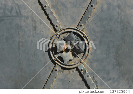 Ornamental wrought iron detail on vintage metal door Ornamental wrought iron detail on vintage metal door 137825964