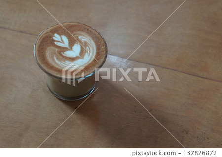 beautiful white cream and milk flower decor in brown and white latte coffee, and ice in low glass on wooden floor background, drink, cool, food, copy space beautiful white cream and milk flower decor in brown and white latte coffee, and ice in low glass on wooden floor background, drink, cool, food, copy space 137826872