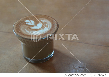 closeup white cream and milk in brown coffee in low glass on wooden floor background, drink, cool, food, copy space closeup white cream and milk in brown coffee in low glass on wooden floor background, drink, cool, food, copy space 137826874