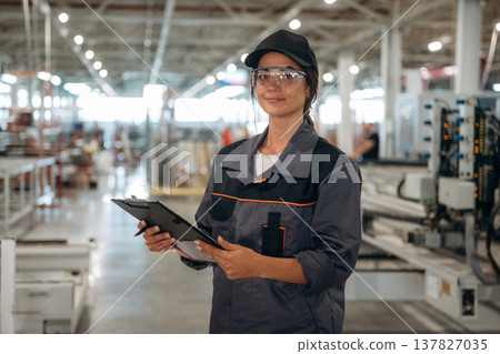Professional uniform. Woman is in the window making factory 137827035