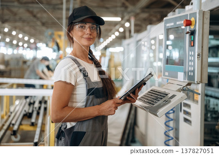 Machinery computer operator. Woman is in the window making factory 137827051