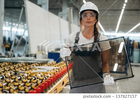 Production line, the conveyor with glass. Woman is in the window making factory 137827157