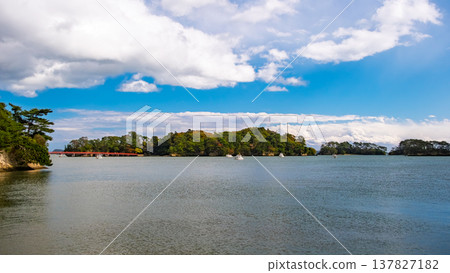 A spectacular view of Fukuura Island and the Deai Bridge (Fukuura Bridge) floating in Matsushima Bay under a clear autumn sky in Matsushima Town, Miyagi Prefecture. A spectacular view of Fukuura Island and the Deai Bridge (Fukuura Bridge) floating in Matsushima Bay under a clear autumn sky in Matsushima Town, Miyagi Prefecture. 137827182