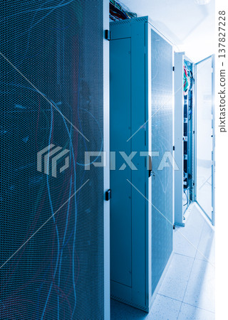 Racks filled with computer hardware inside internet datacenter 137827228