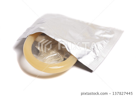 condom in foil packaging isolated on white background 137827445