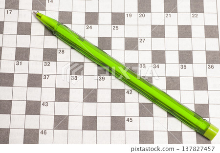 Crossword puzzle with ballpoint pen. Crossword puzzle with ballpoint pen. 137827457
