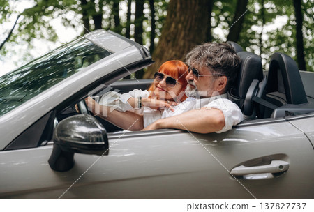 Feeling good, going for vacation. Senior couple driving convertible cabriolet car 137827737