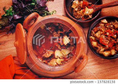 Chanakhi, a Georgian dish. in a clay pot, on a wooden table, stewed meat with vegetables, homemade, no people, Chanakhi, a Georgian dish. in a clay pot, on a wooden table, stewed meat with vegetables, homemade, no people, 137828138