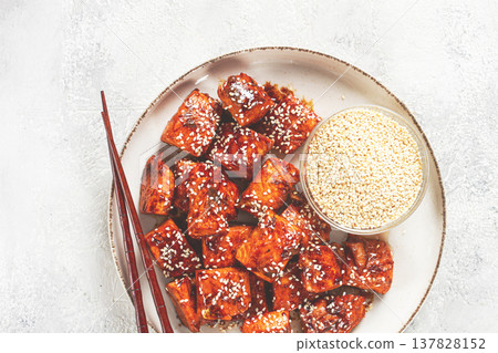fried pieces of salmon teriyaki with sesame seeds, top view, 137828152