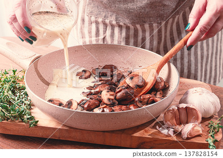 cooking sauce with mushrooms, a woman pours cream into a pan with mushrooms, natural light, lifestyle, cooking sauce with mushrooms, a woman pours cream into a pan with mushrooms, natural light, lifestyle, 137828154