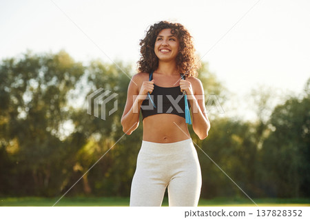 Good attitude, standing. Young fitness woman is on the field outdoors 137828352