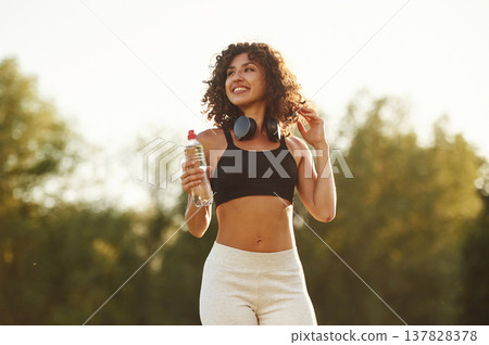 Good attitude, standing. Young fitness woman is on the field outdoors 137828378
