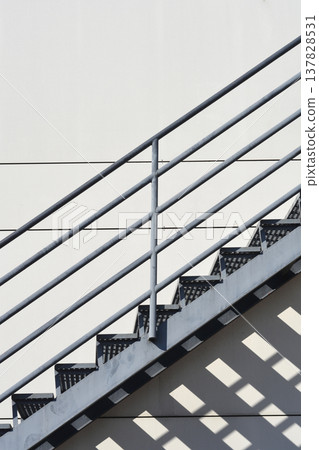 Metal external staircase with geometric shadows 137828531