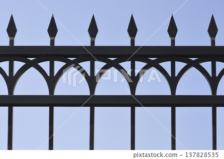 Black wrought iron fence with pointed spikes Black wrought iron fence with pointed spikes 137828535