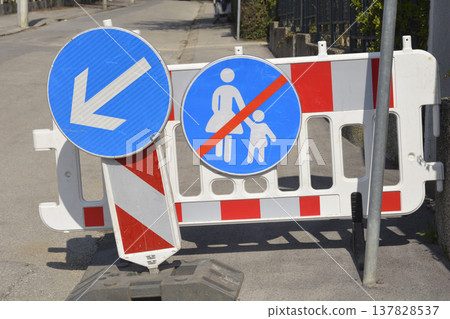 Blue traffic signs and road barriers on a city street Blue traffic signs and road barriers on a city street 137828537