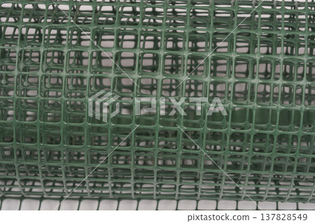 Close up of green plastic garden mesh texture Close up of green plastic garden mesh texture 137828549