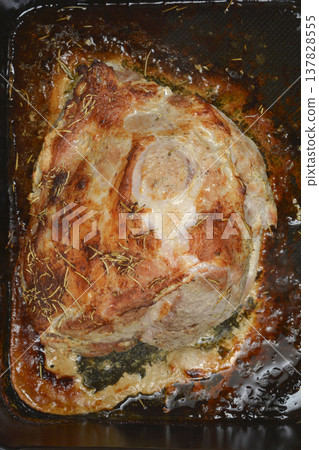 Roasted pork meat with rosemary in a baking pan 137828555