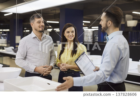 Happy Couple Choosing Sink With Consultant Happy Couple Choosing Sink With Consultant 137828606