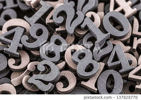 Pile of old wooden numbers in vintage style. Mathematics, education and learning concept. Pile of old wooden numbers in vintage style. Mathematics, education and learning concept. 137828770