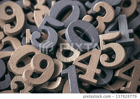 Pile of old wooden numbers in vintage style. Mathematics, education and learning concept. Pile of old wooden numbers in vintage style. Mathematics, education and learning concept. 137828779