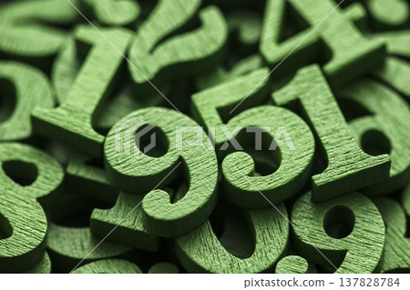 Pile of green painted wooden numbers in vintage style. Mathematics, education and learning concept. Pile of green painted wooden numbers in vintage style. Mathematics, education and learning concept. 137828784