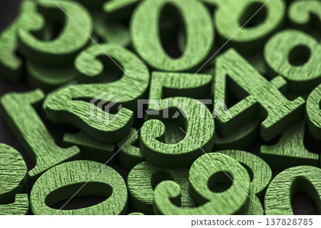 Pile of green painted wooden numbers in vintage style. Mathematics, education and learning concept. Pile of green painted wooden numbers in vintage style. Mathematics, education and learning concept. 137828785