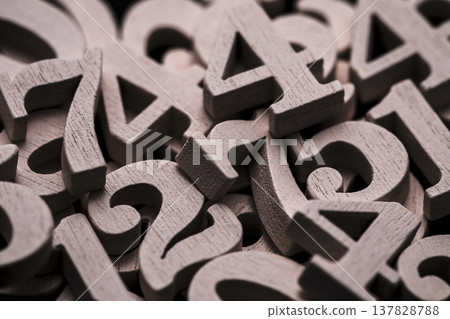 Pile of old wooden numbers in vintage style. Mathematics, education and learning concept. Pile of old wooden numbers in vintage style. Mathematics, education and learning concept. 137828788