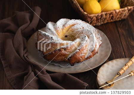 Lemon bundt cake powdered sugar on wooden table Lemon bundt cake powdered sugar on wooden table 137829503