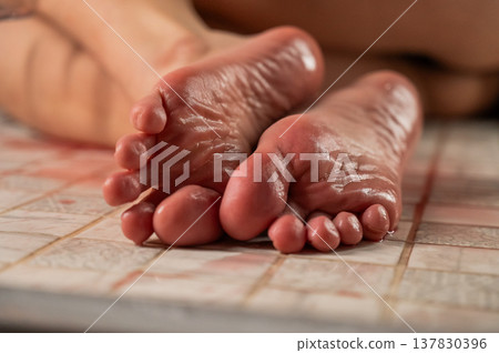 Foot fetish. A woman pours wine on her feet. 137830396