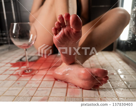 Foot fetish. A woman pours wine from a glass onto her feet in the shower. 137830403