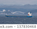 Ocean cargo ship sailing across the cloudy sea 137830468