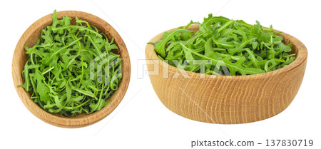 Heap of green fresh rucola or arugula leaf in wooden bowl isolated on white background. Top view, flat lay Heap of green fresh rucola or arugula leaf in wooden bowl isolated on white background. Top view, flat lay 137830719
